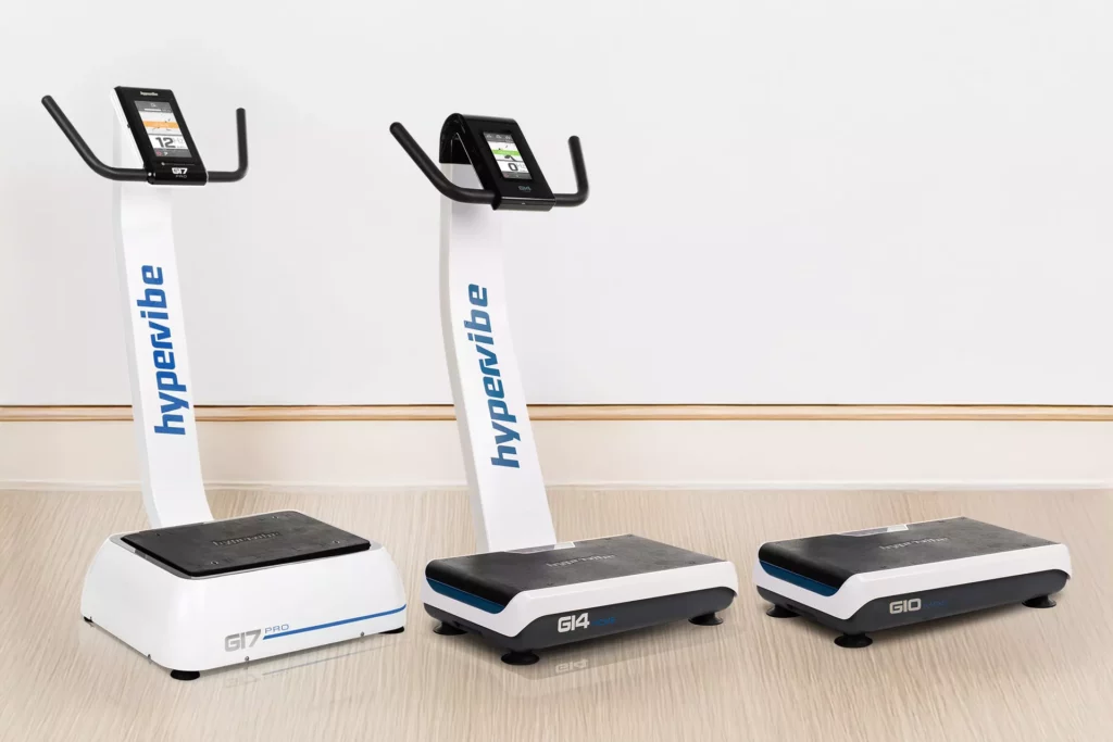 How To Use A Vibration Plate For Back Pain: Positions, Timings And Real-World Hypervibe Routines 22 Three different Hypervibe vibration plate models: the G17 Pro, G14 Home, and G10 Mini, displayed side-by-side on a light wood floor.