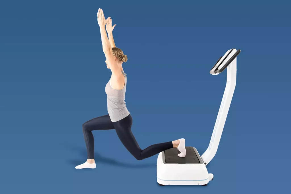 Top Vibration Plate Exercises: A Complete Guide To Safe Whole-Body Vibration Workouts 17 Woman performing an elevated split squat with her rear foot on a vibration plate and arms reaching upward.