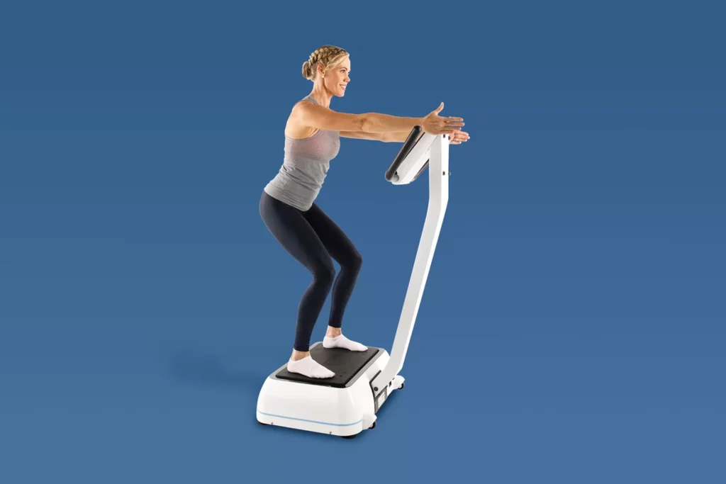 Top Vibration Plate Exercises: A Complete Guide To Safe Whole-Body Vibration Workouts 8 Woman performing a functional squat on a Hypervibe vibration plate to engage leg muscles.