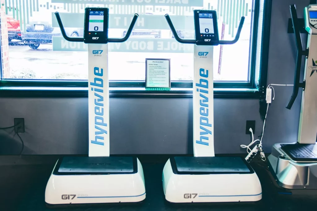 Can You Use A Vibration Plate After Knee Replacement? A Real-World Rehab Guide 5 Two Hypervibe whole body vibration machines side by side in a clinic setting.