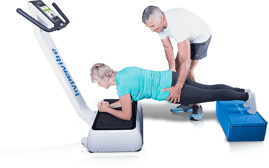 Vibration Plate Calories Burned Calculator: How Many Calories You Really Burn 8 A personal trainer assisting an older woman performing a forearm plank exercise with her arms on a Hypervibe vibration machine