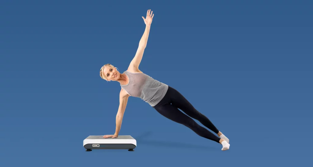 Fit woman doing a side plank on a Hypervibe G10 Platform