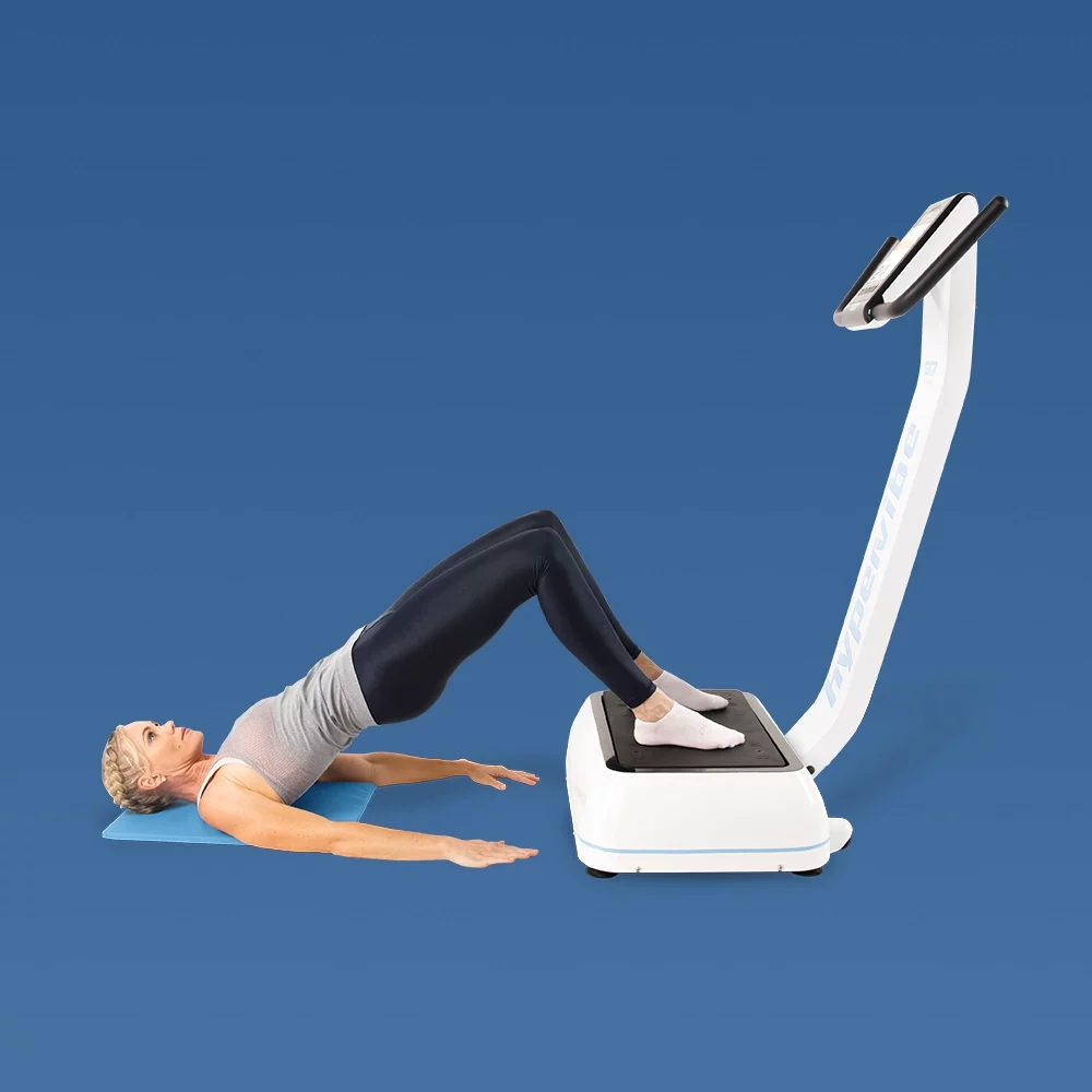 Woman doing hip thrusts on Hypervibe vibration platform