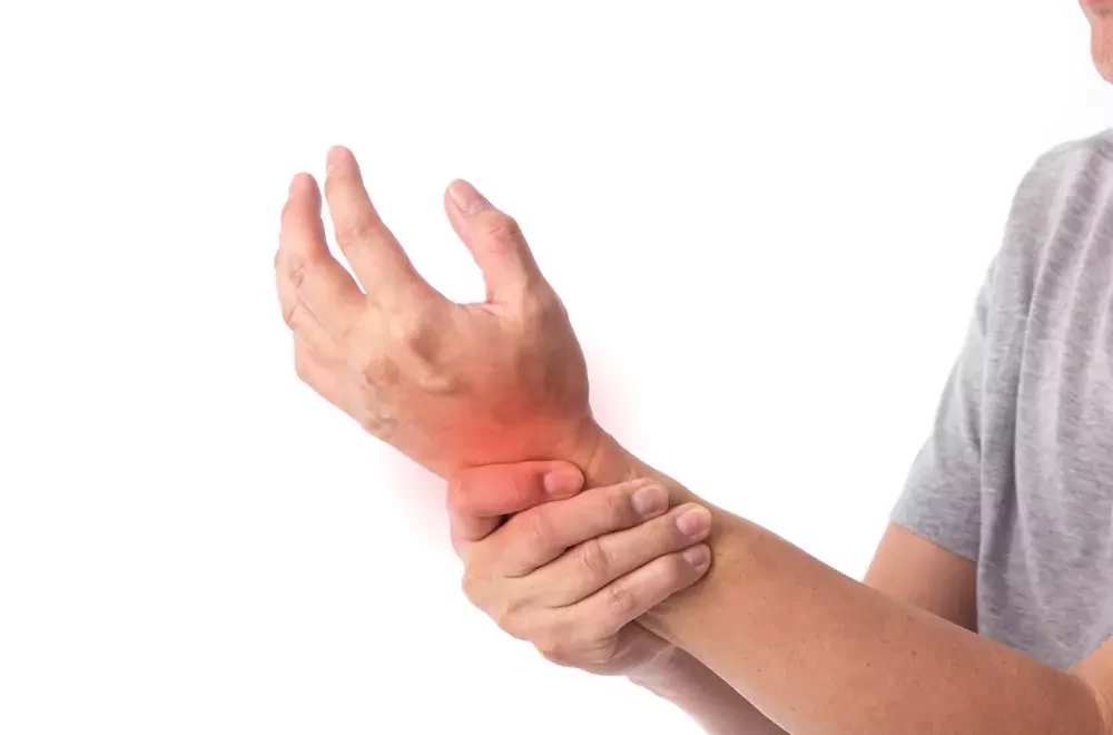 Man holding his wrist in pain, signifying joint pain from arthritis
