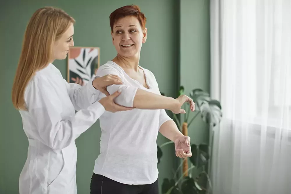 A therapist assisting a patient with a hand stretch