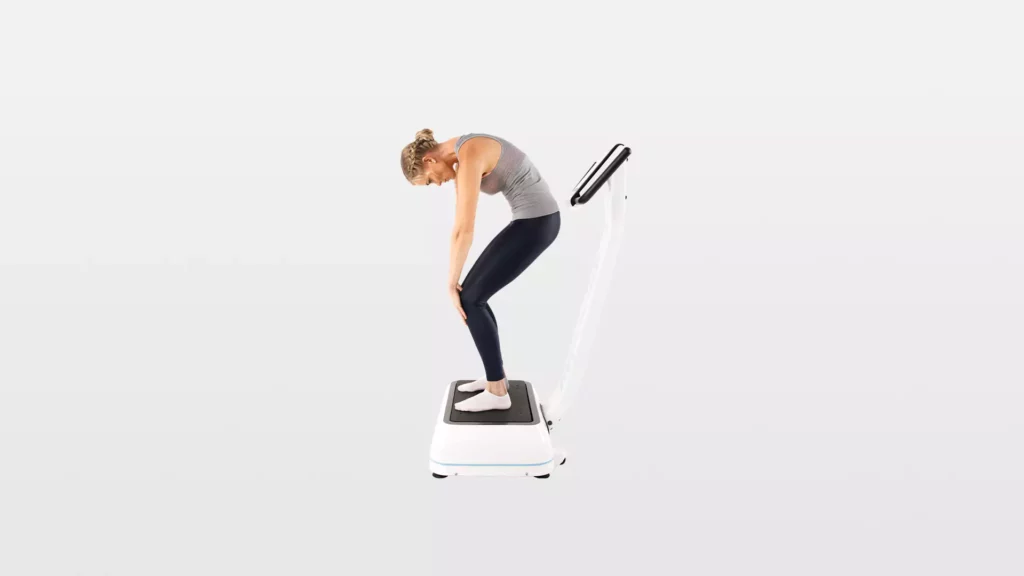 woman doing a Low Back-Hamstring-Calf Stretch on a vibration platform