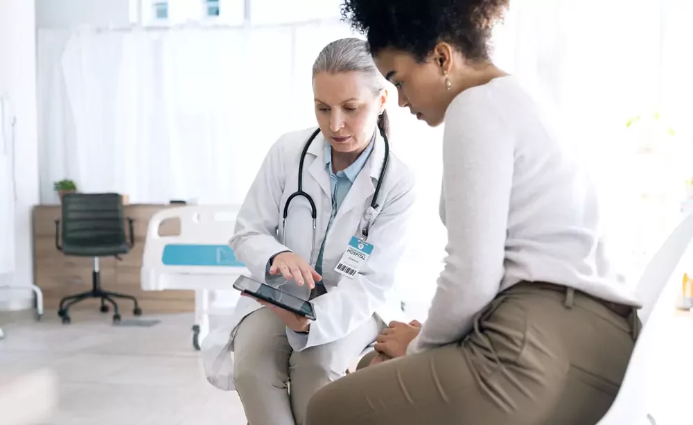 A female medical practitioner reassuring a patient