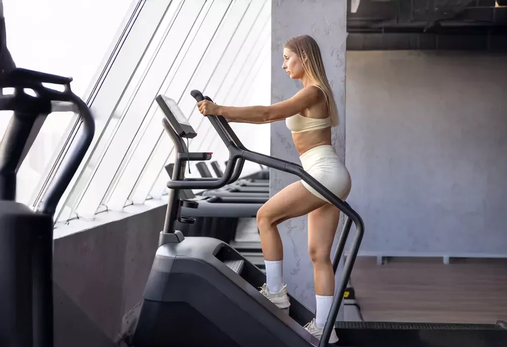 woman works out on a stair climber