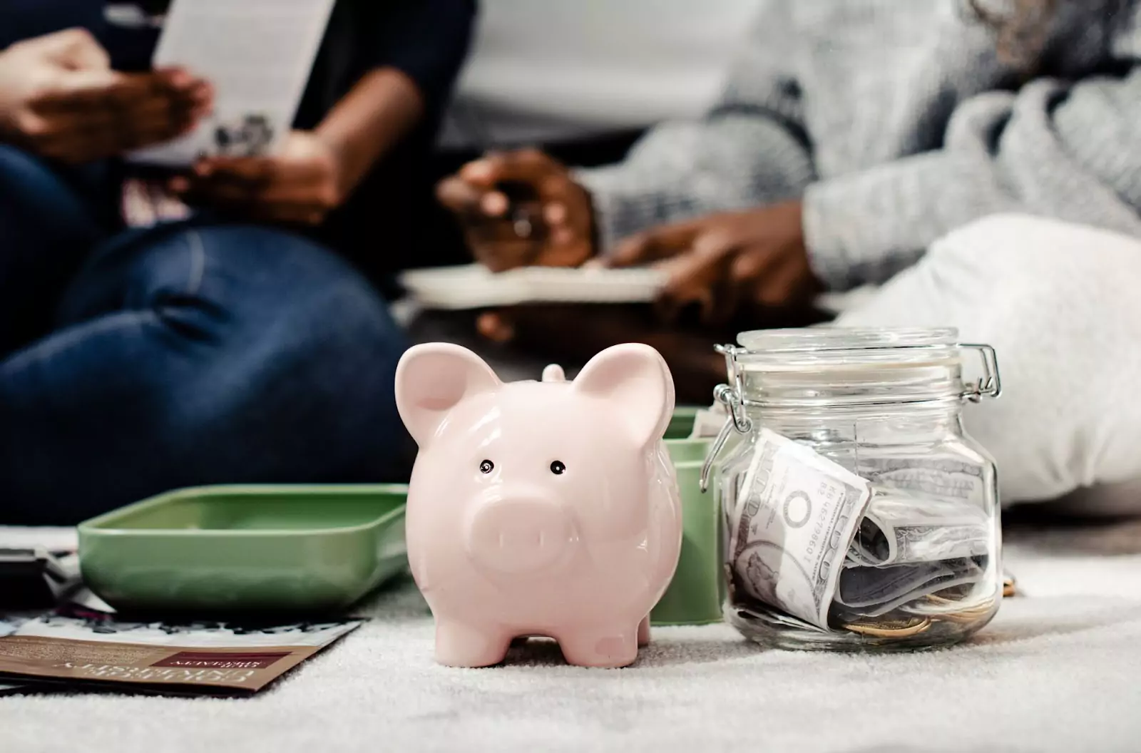Illustration of a piggy bank surrounded by dollar bills and coins, representing budget tier recommendations for comparing whole body vibration machines by price.
