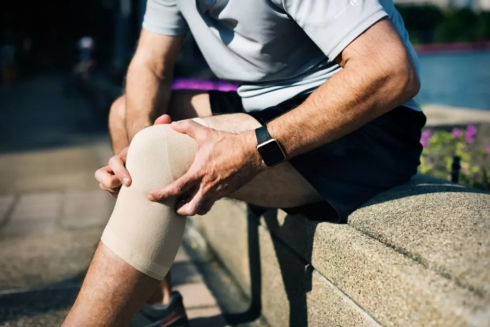 Man struggling with knee pain